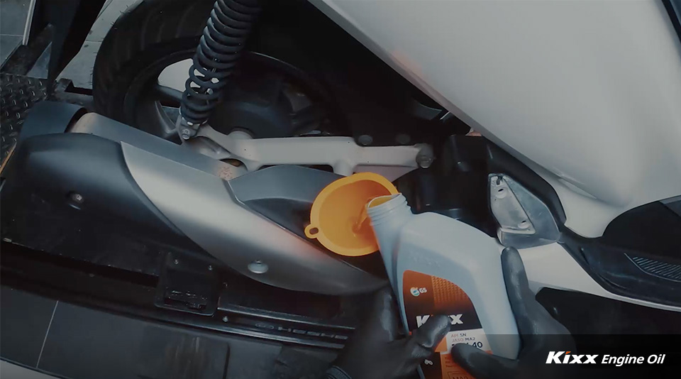 An oil tank being filled with fresh engine oil