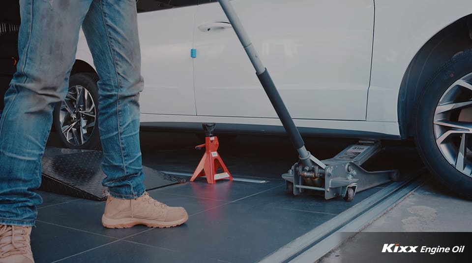 Image of a mechanic lifting a car using a safety device