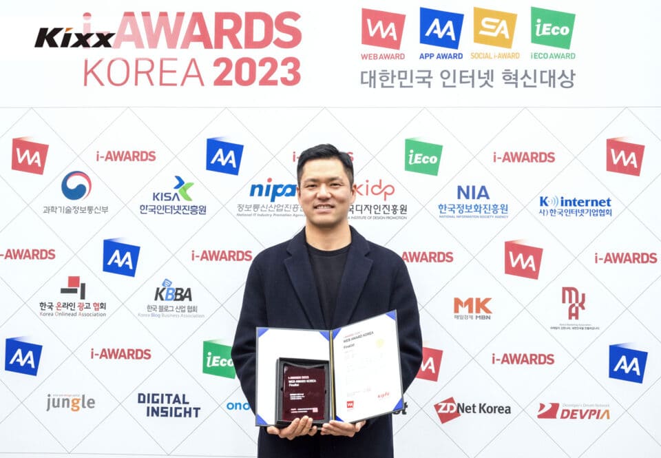 A photo of a person holding a certificate and smiling brightly