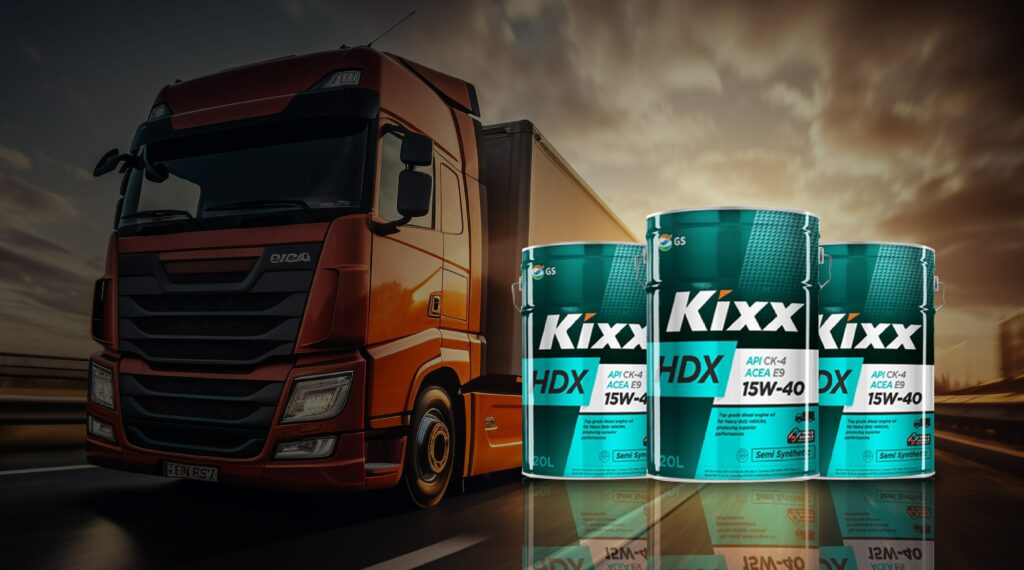 A banner with a background image of a heavy-duty truck and three cans of Kixx HDX engine oil.