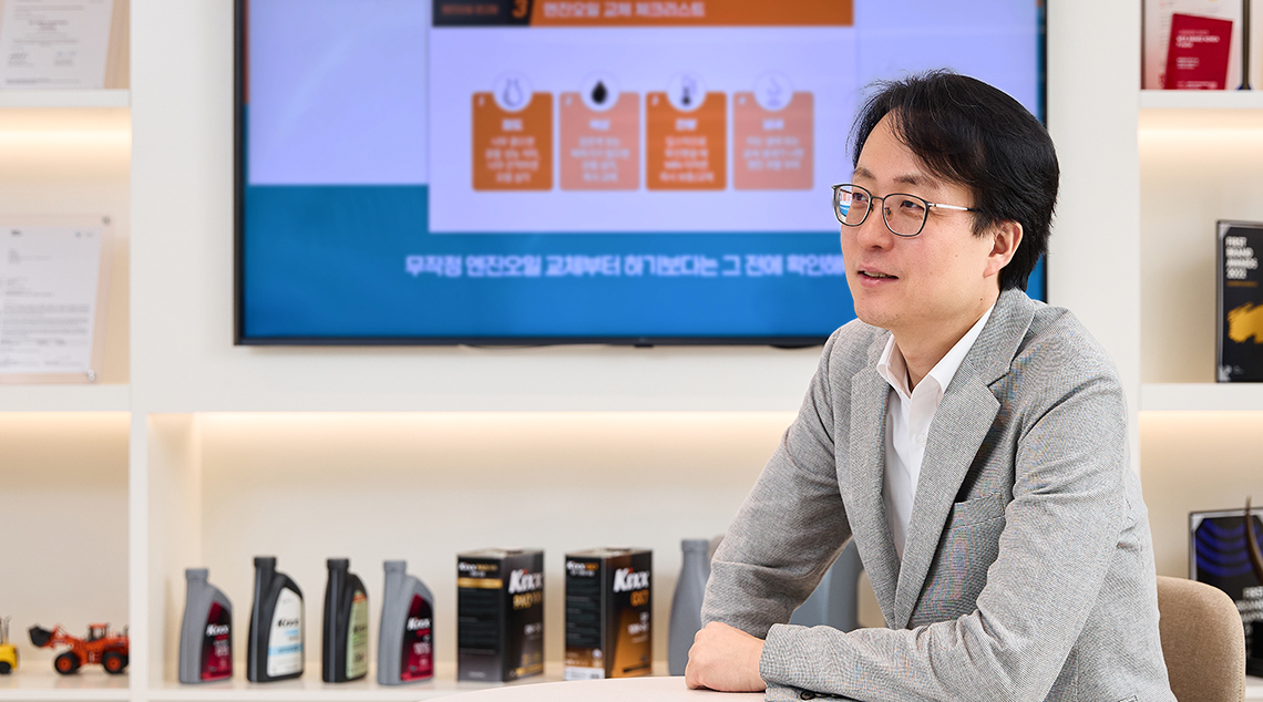 Image 4 | Kixx Newsroom Changbeom Lee sits in a room filled with Kixx products and a TV
