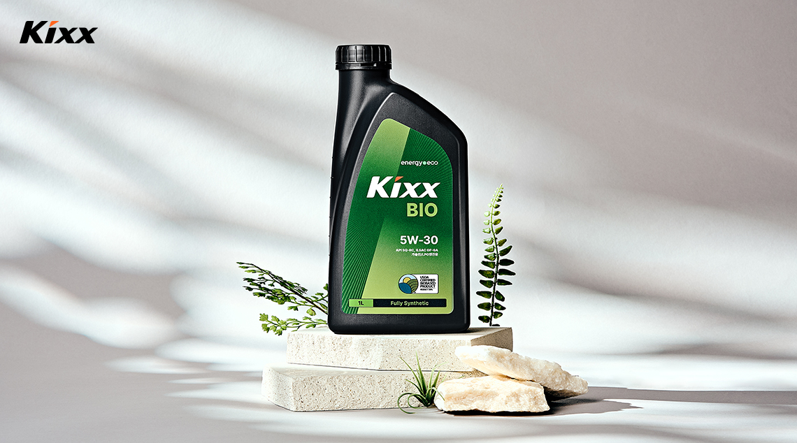 Image 2 | Kixx Newsroom A bottle of Kixx BIO sits on stones in front of a white backdrop with shadows falling across it.